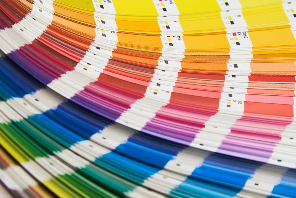 A fan of color swatches on a designer's workspace