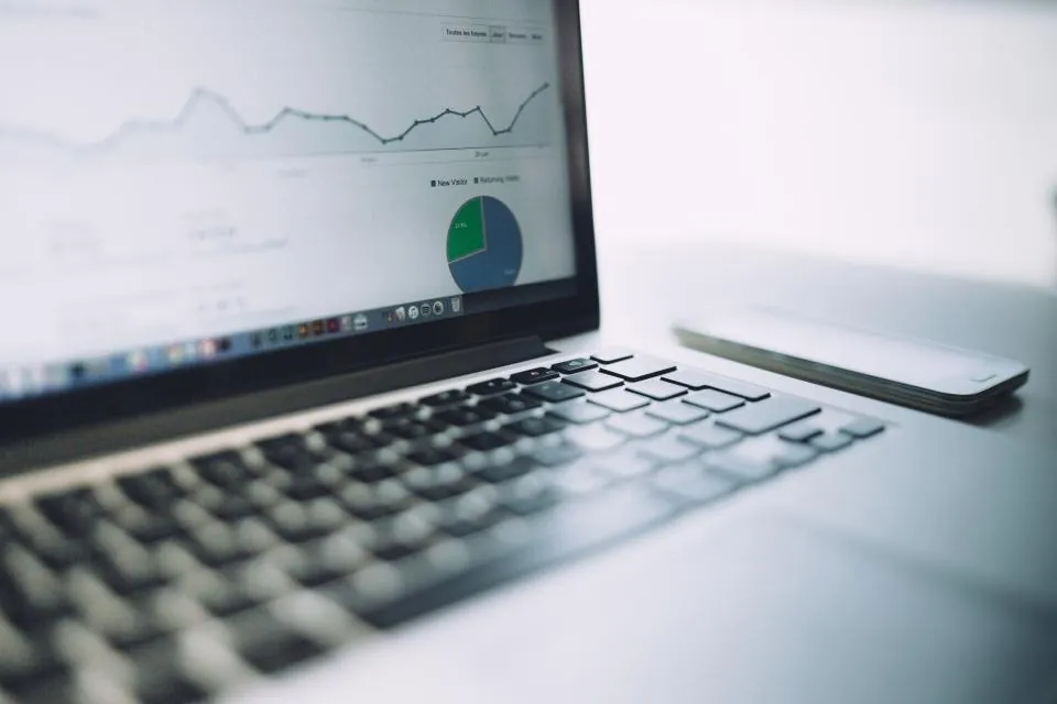 A laptop displaying business analytics and charts