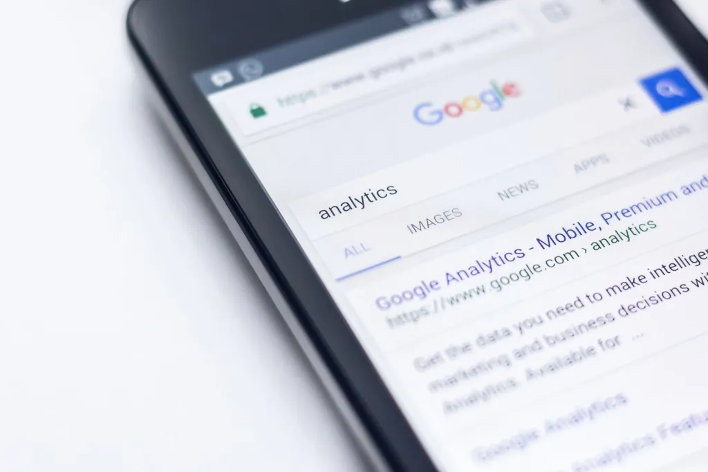 A smartphone showing Google search results for analytics
