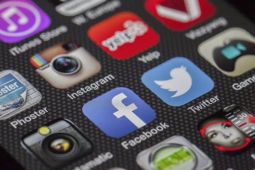 A smartphone screen filled with social media app icons including Facebook, Instagram, and Twitter